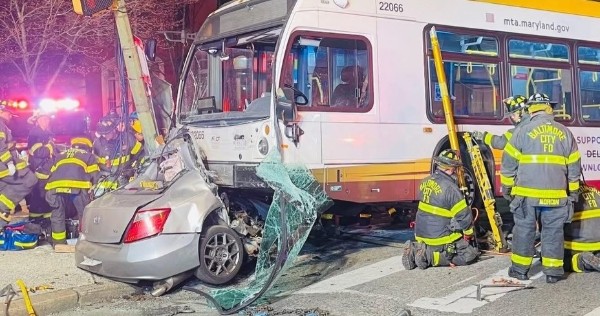 Emergency responders at the scene of a collision between a car and an MTA bus